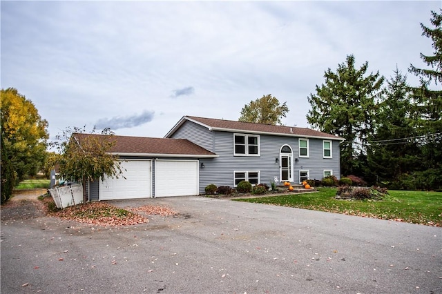 view of front of house with a garage and a front lawn