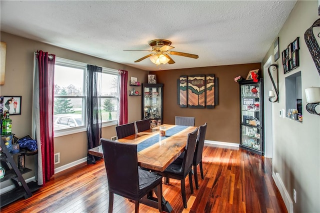 dining area with hardwood / wood-style floors, a textured ceiling, and ceiling fan