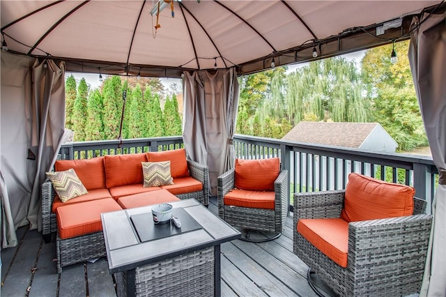 wooden terrace with a gazebo and an outdoor living space