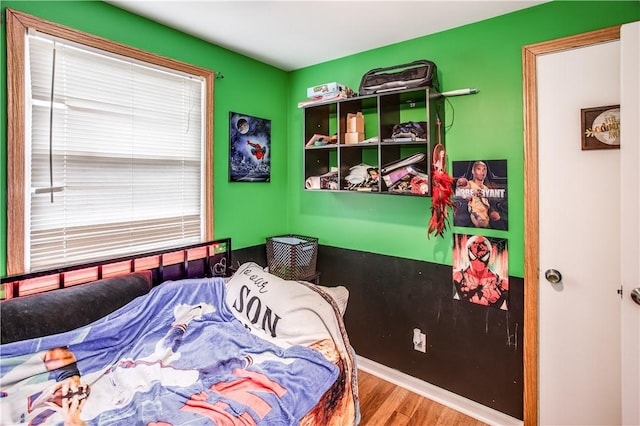 bedroom with hardwood / wood-style flooring