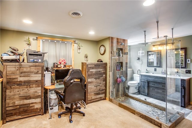 home office with light colored carpet and sink