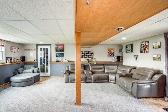 carpeted living room with bar area and a paneled ceiling