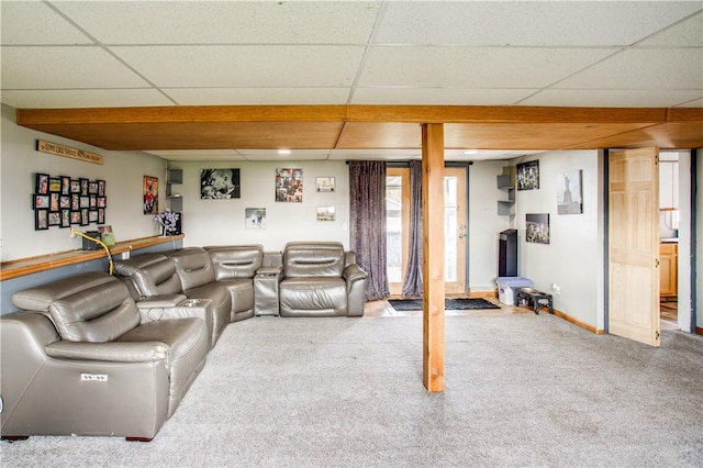 living room featuring carpet flooring and a drop ceiling