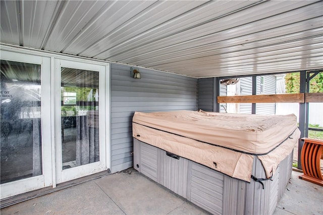 sunroom featuring a healthy amount of sunlight and a hot tub