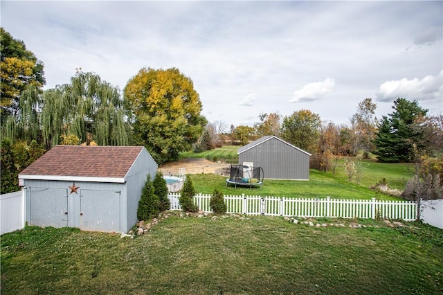 view of yard with an outdoor structure and a trampoline