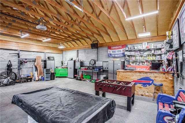 game room featuring a workshop area, billiards, and concrete floors