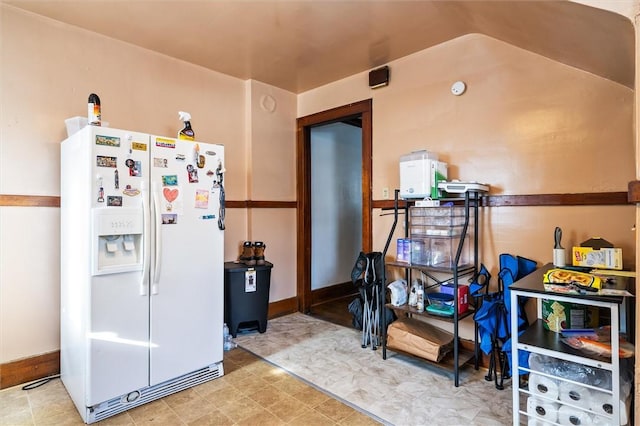 kitchen featuring white fridge with ice dispenser