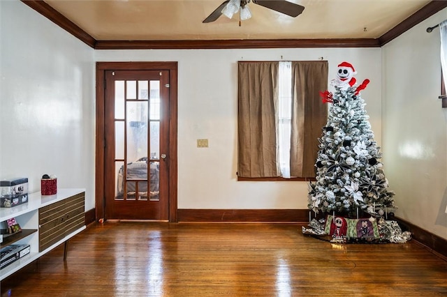 interior space featuring ceiling fan, ornamental molding, and hardwood / wood-style flooring