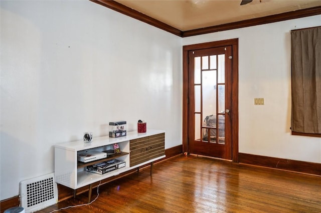 foyer entrance featuring dark hardwood / wood-style floors and crown molding