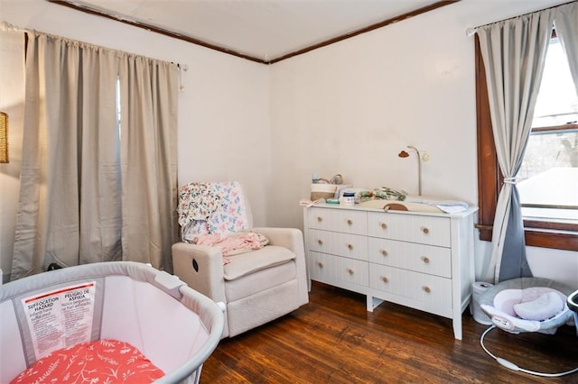 sitting room with dark hardwood / wood-style floors and crown molding