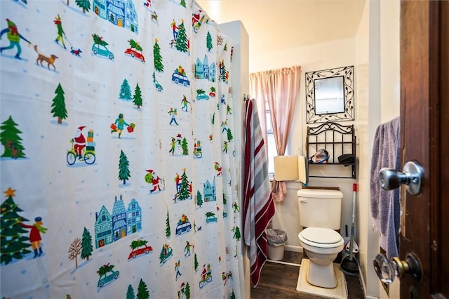 bathroom with wood-type flooring, toilet, and walk in shower