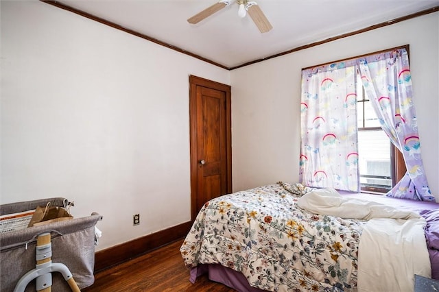 bedroom featuring ceiling fan, dark hardwood / wood-style floors, and crown molding