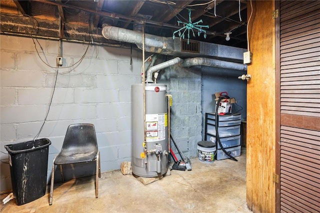 utility room featuring gas water heater