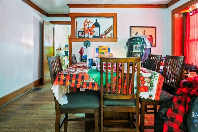 dining area featuring crown molding and dark hardwood / wood-style flooring