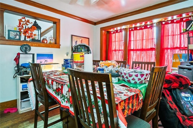 dining area with wood-type flooring and ornamental molding