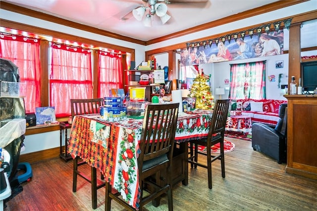 dining room featuring ornamental molding, ceiling fan, and dark wood-type flooring