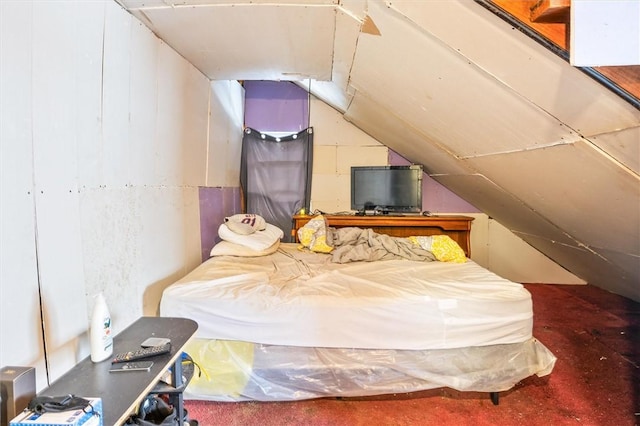 bedroom featuring carpet floors and vaulted ceiling