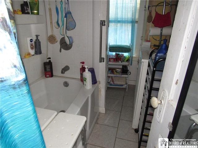 bathroom featuring tile patterned flooring and a bathtub