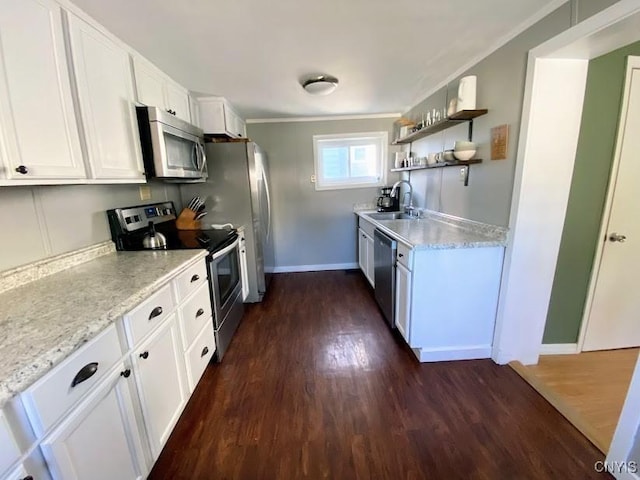 kitchen featuring sink, dark wood-type flooring, stainless steel appliances, crown molding, and white cabinets