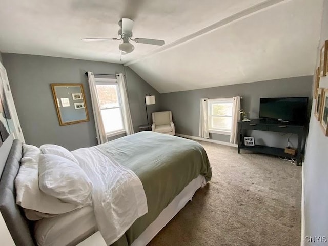 carpeted bedroom featuring multiple windows, lofted ceiling, and ceiling fan