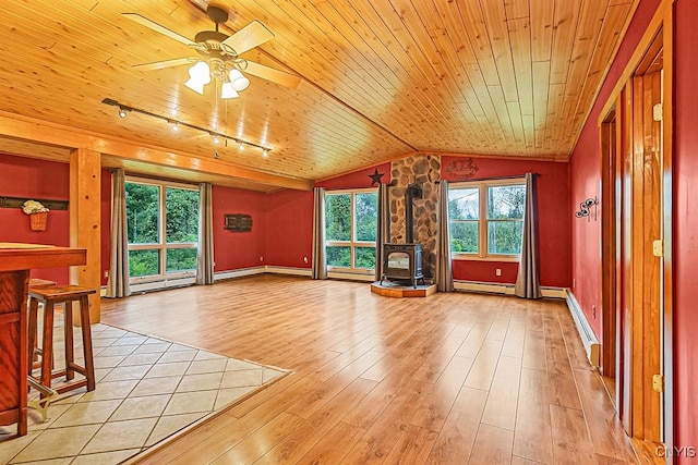 unfurnished living room with baseboard heating, light hardwood / wood-style flooring, wooden ceiling, a wood stove, and lofted ceiling