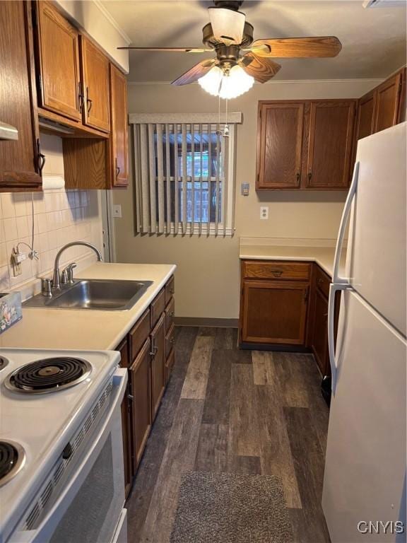 kitchen with ceiling fan, sink, dark wood-type flooring, backsplash, and white appliances