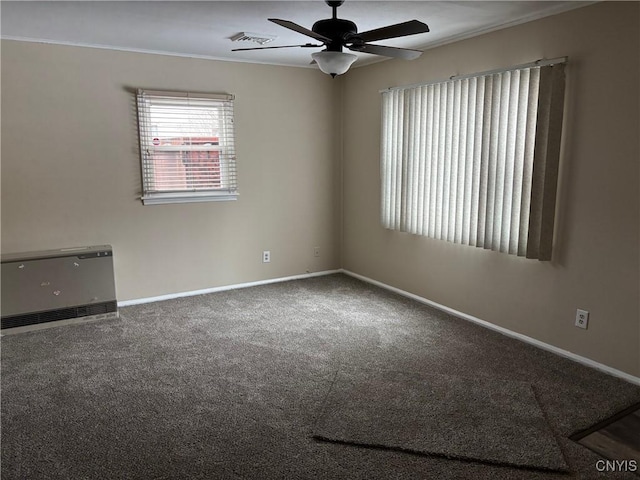 carpeted empty room featuring ceiling fan and ornamental molding