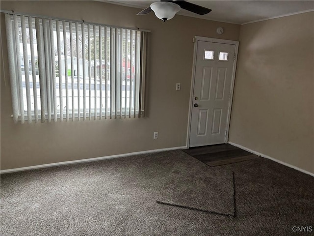 entryway featuring carpet and ceiling fan