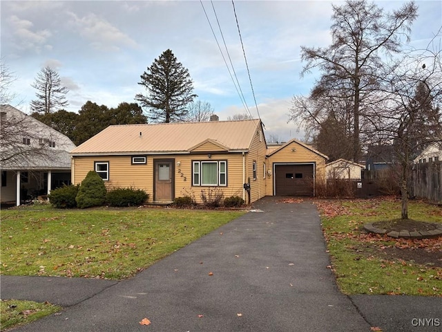 view of front of property with an outbuilding, a front yard, and a garage