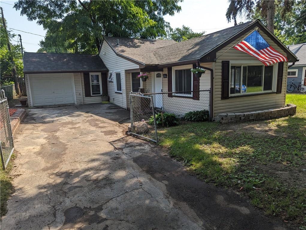 view of front of home with a garage and an outdoor structure