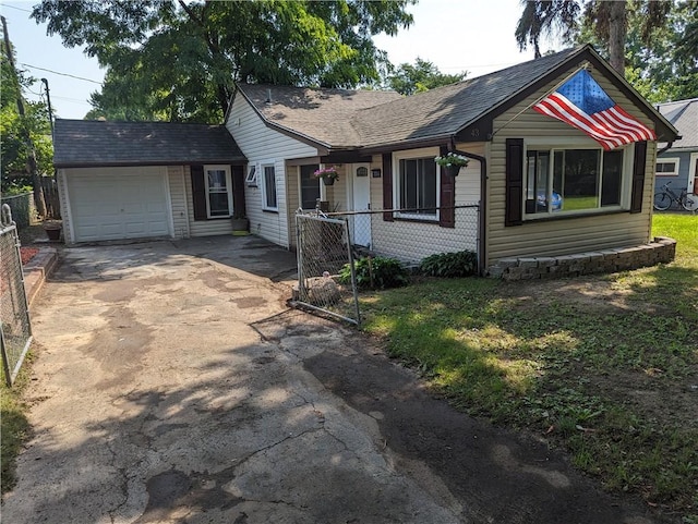 view of front of home with a garage and an outdoor structure