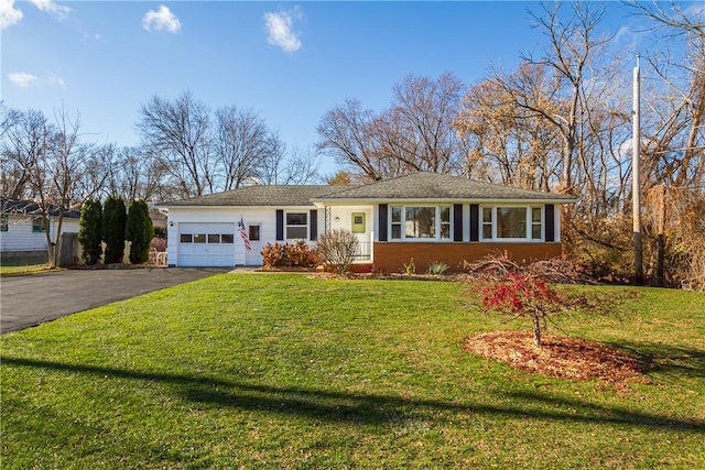 ranch-style house with a garage and a front lawn