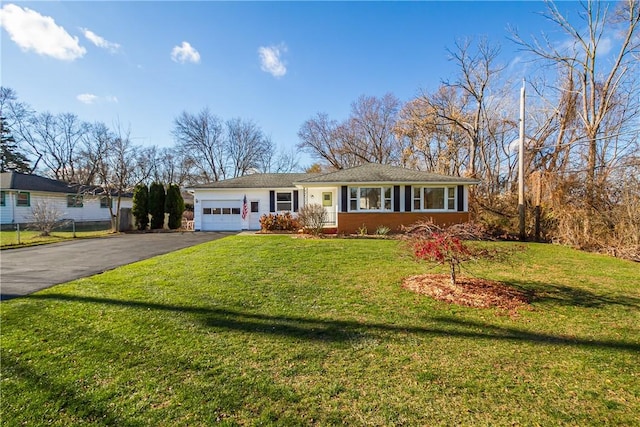 single story home with a front yard and a garage