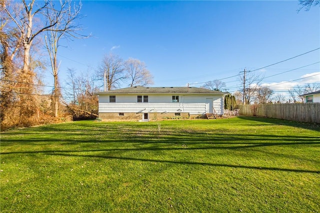 rear view of property with a yard