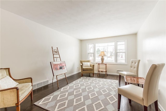 sitting room with dark hardwood / wood-style flooring