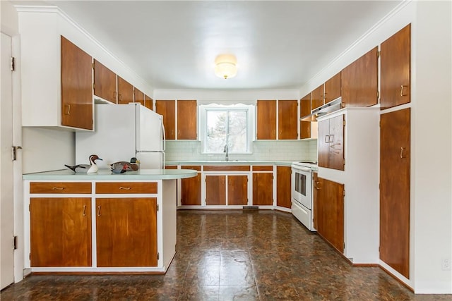 kitchen with decorative backsplash, sink, and white appliances