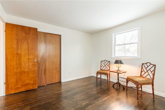 sitting room with dark hardwood / wood-style floors