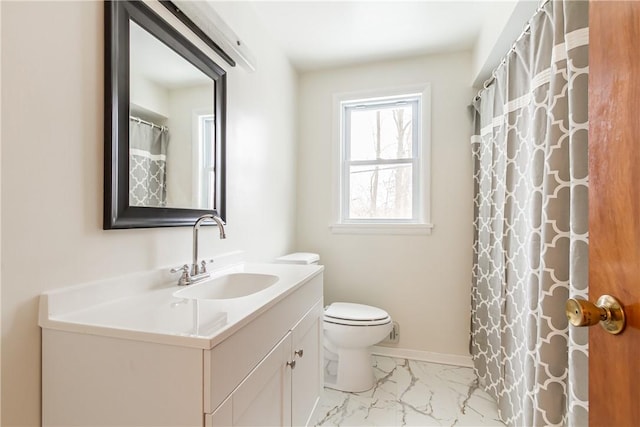 bathroom with vanity, toilet, and curtained shower