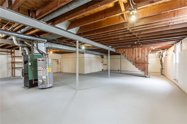 basement featuring gas water heater and heating unit