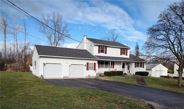 view of front of property with a porch, a garage, and a front yard