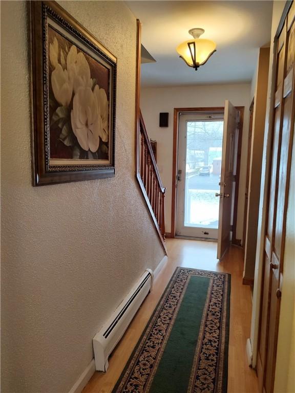 entryway featuring baseboard heating and light wood-type flooring