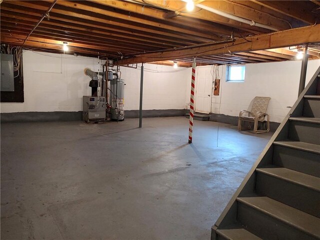 basement featuring electric panel and water heater