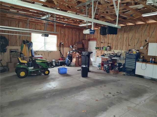 garage featuring a workshop area and a garage door opener