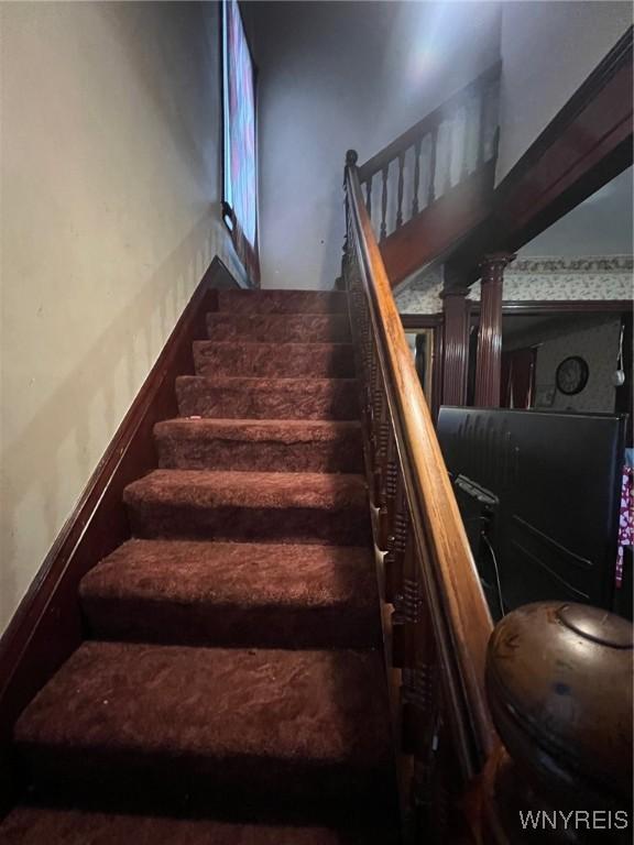 stairway with ornate columns