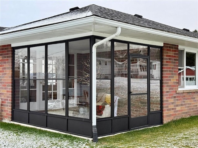 view of home's exterior with a sunroom