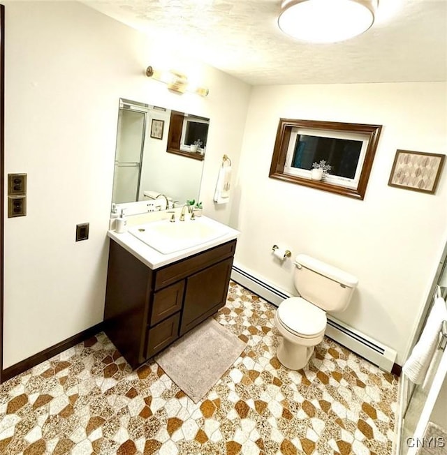 bathroom featuring vanity, toilet, a textured ceiling, and a baseboard radiator