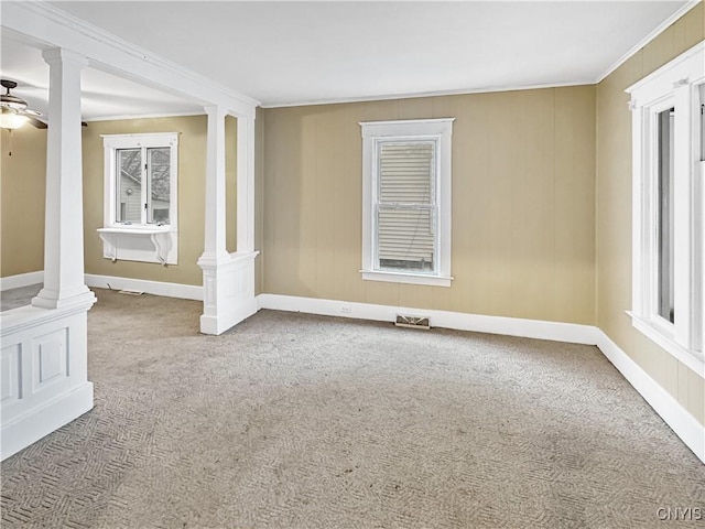 carpeted empty room featuring crown molding and ceiling fan