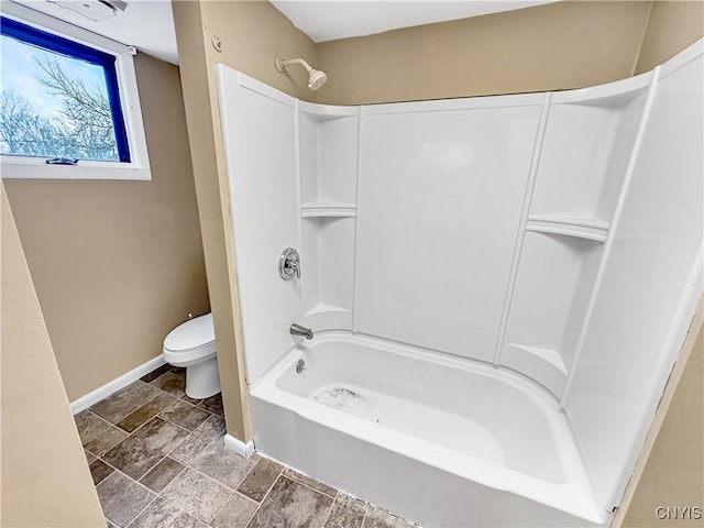 bathroom featuring toilet and bathtub / shower combination