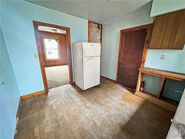 kitchen featuring wood-type flooring and white refrigerator