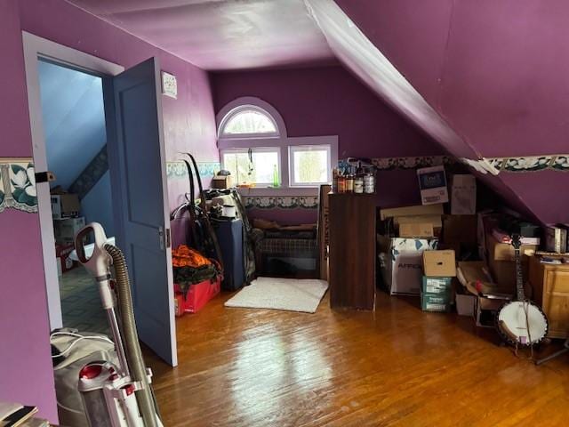 bonus room with lofted ceiling and wood finished floors